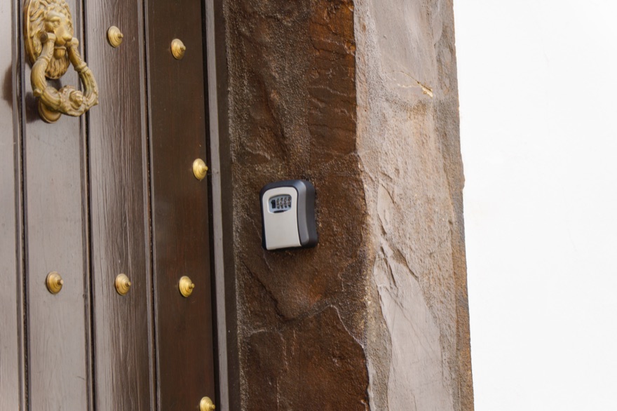 Key safe beside the studded wooden door of an Italian townhouse